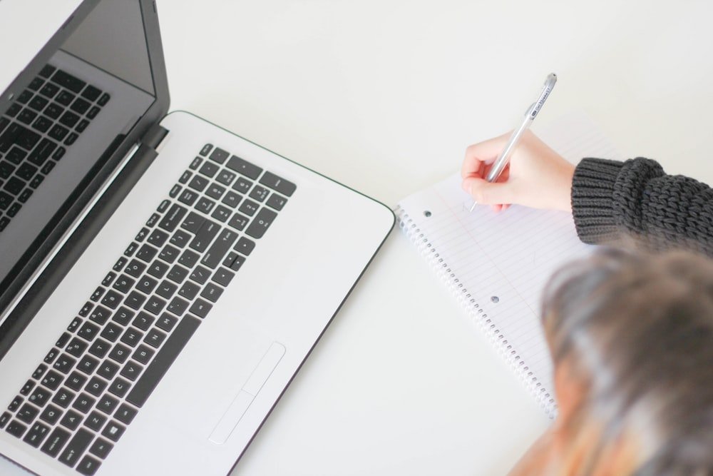 Description: woman writing on notebook